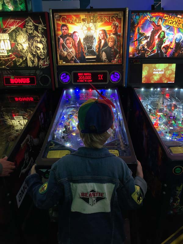 Silas playing pinball in September of 2019